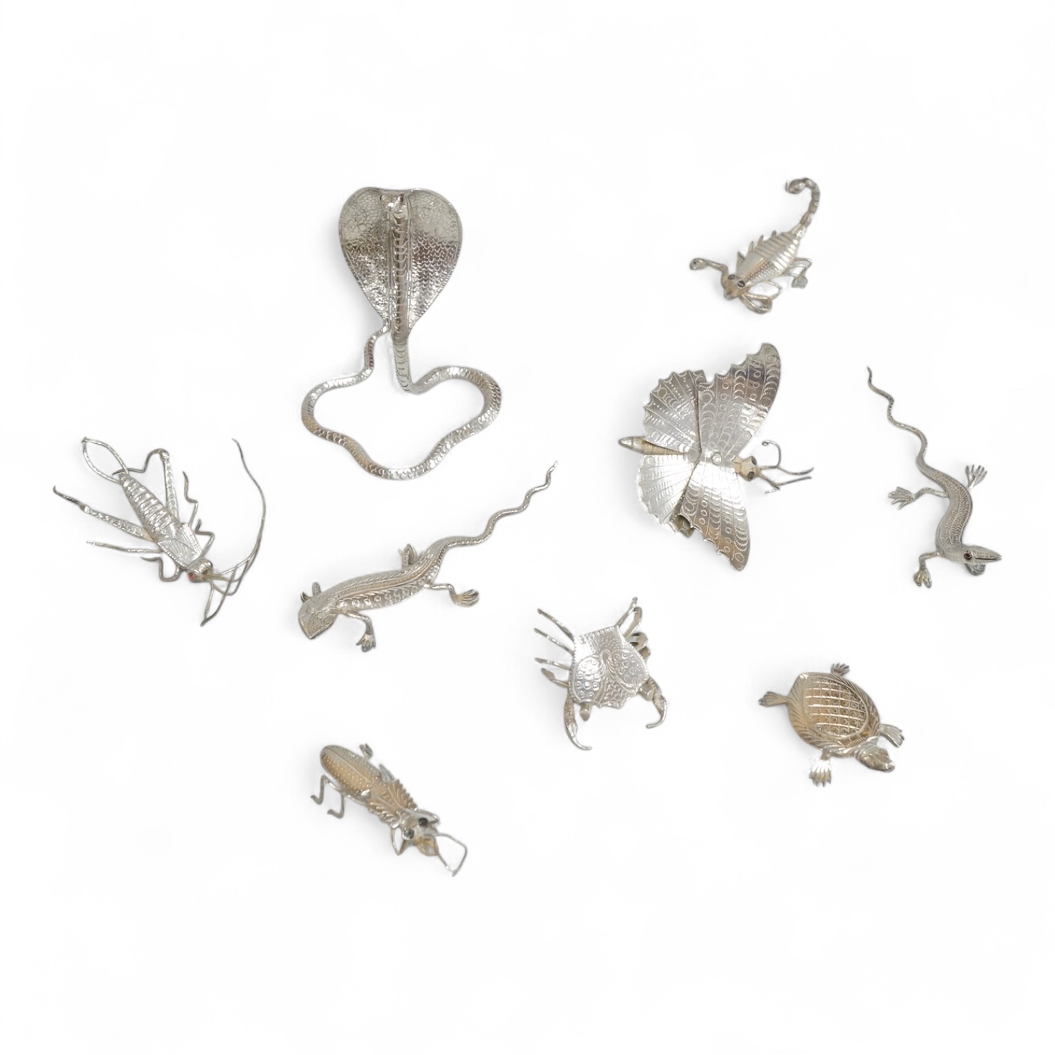 A group of nine assorted Indian white metal miniature model insects and reptiles, etc. including a King Cobra, scorpion, lizards, turtle, butterfly and crab etc.